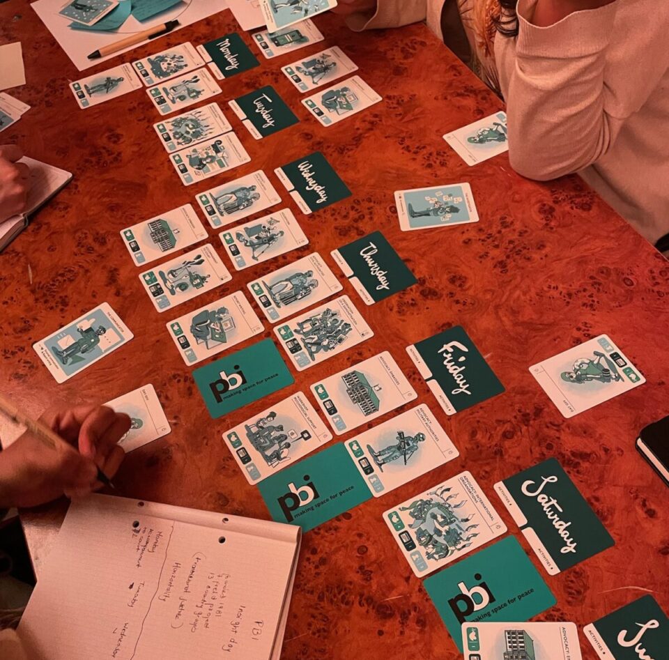 Participants play the PBI card game